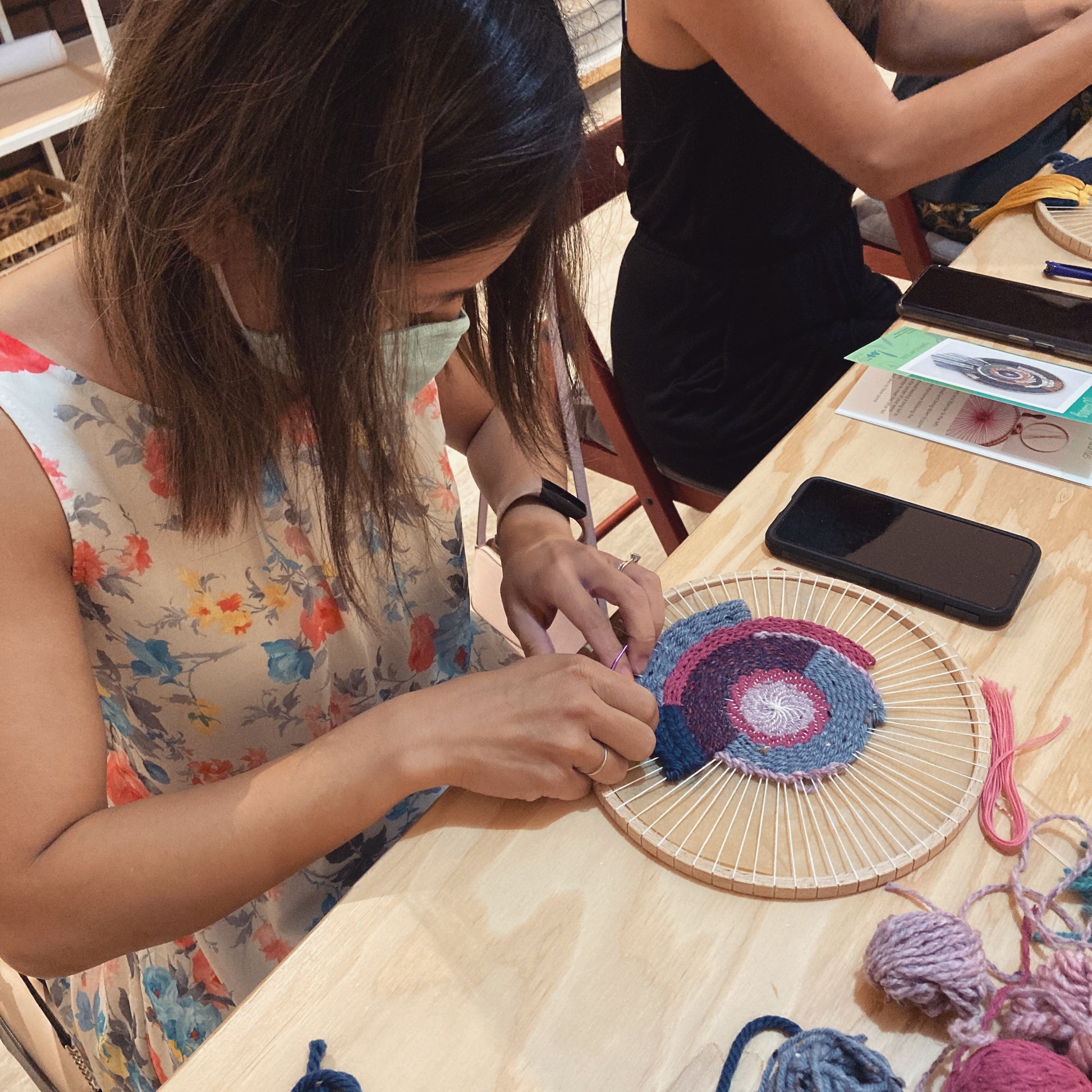 Student working on botanical circular weaving